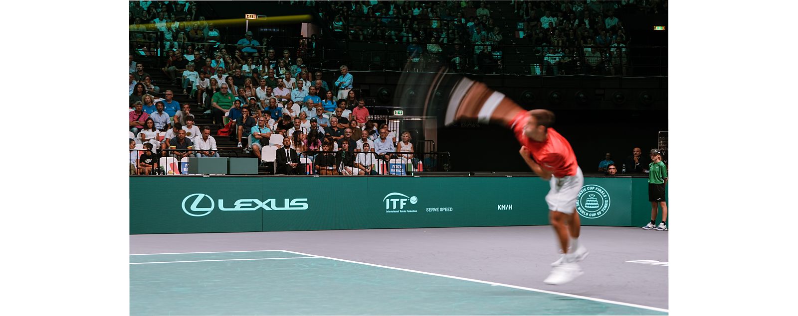 A tennis player serving on a Lexus X ATP court