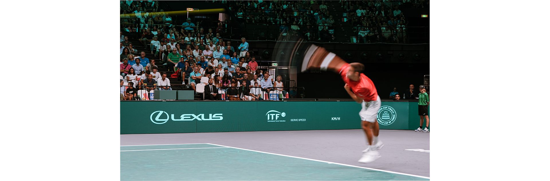 A tennis player serving on a Lexus X ATP court