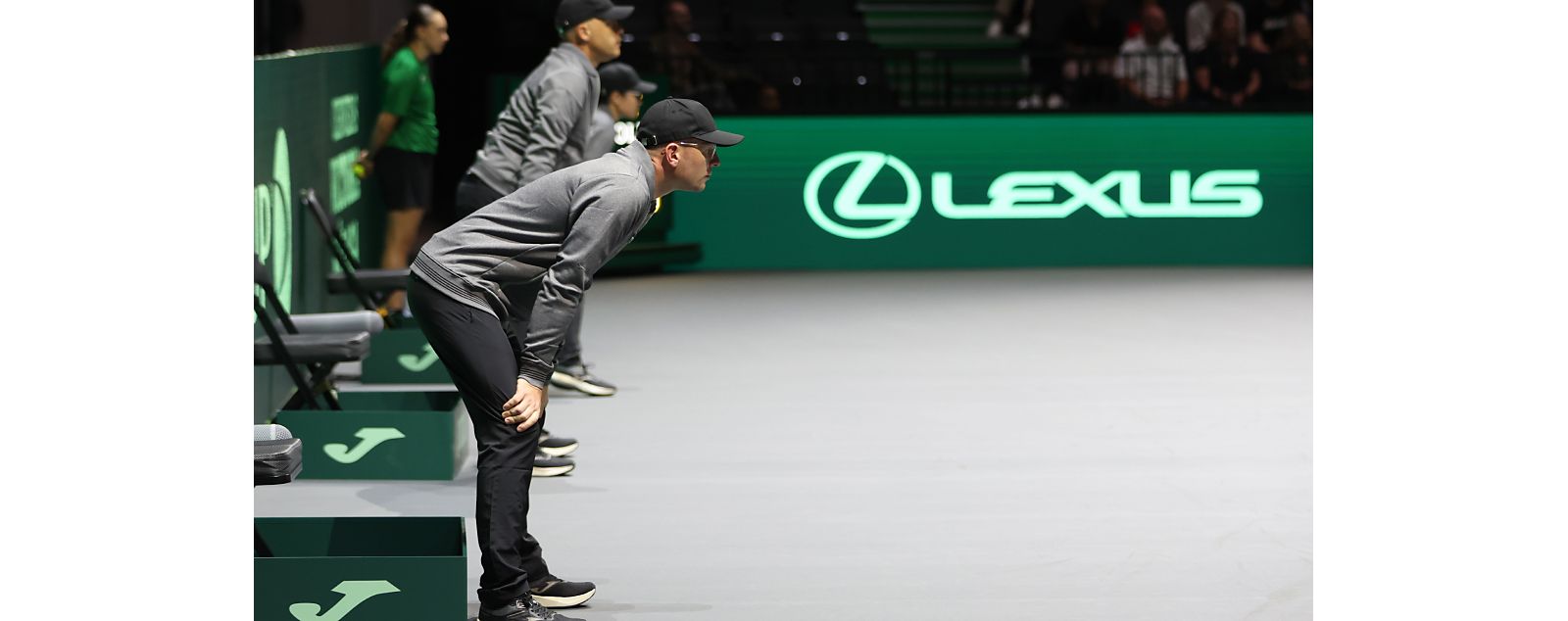 Line judges stood at the side of a tennis court