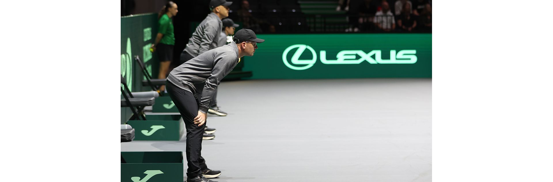 Line judges stood at the side of a tennis court