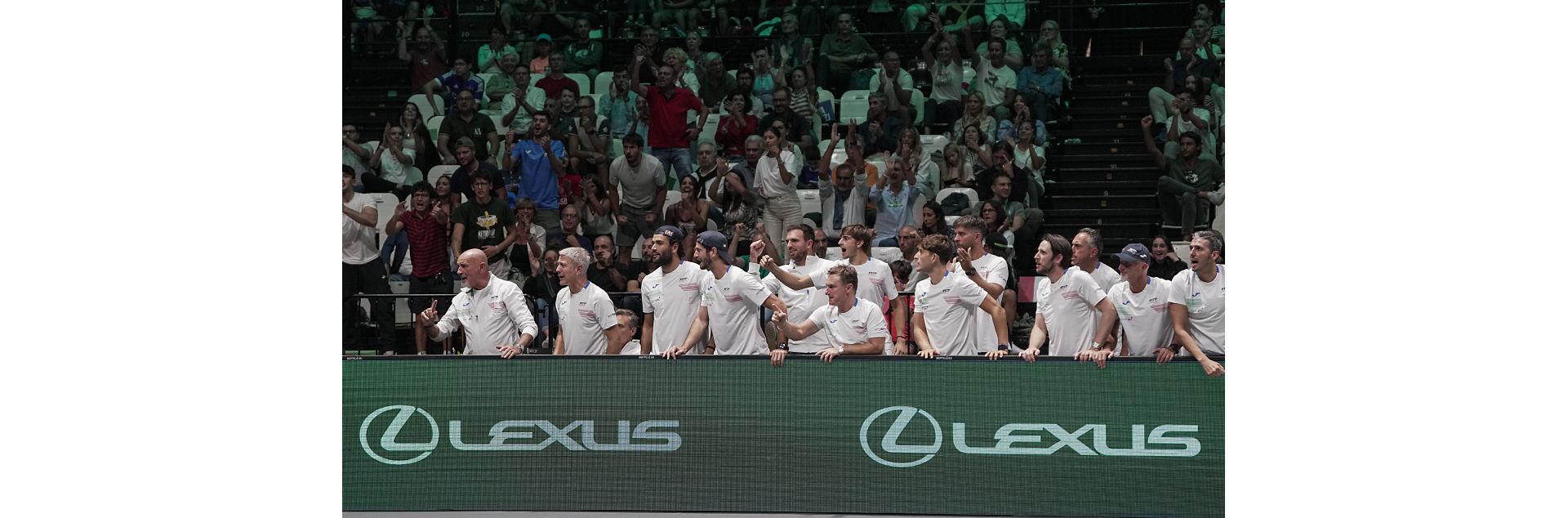 Fans at a tennis event watching on