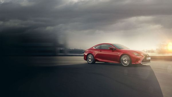 Lexus LC and LC Convertible parked in front of a racetrack 