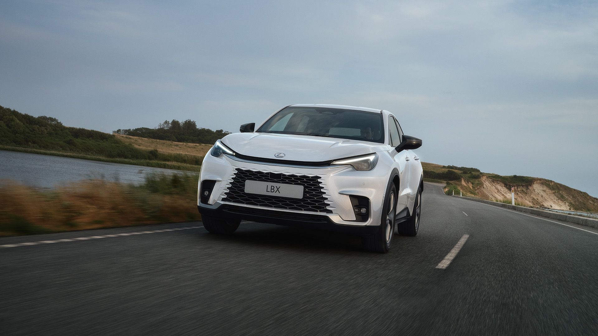 A Lexus LBX driving along the coast