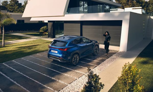 woman standing next to a Lexus NX 350 car