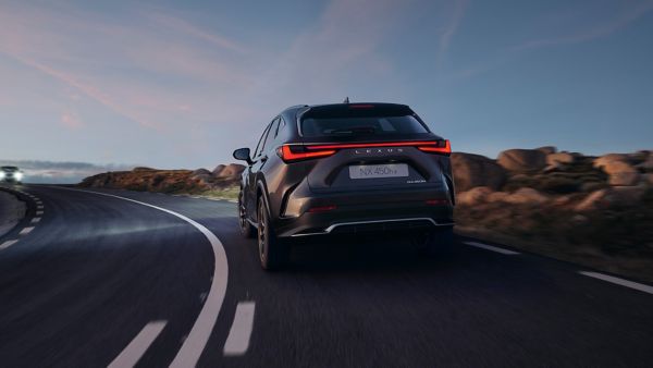 Lexus NX 450h+ driving on a rural road