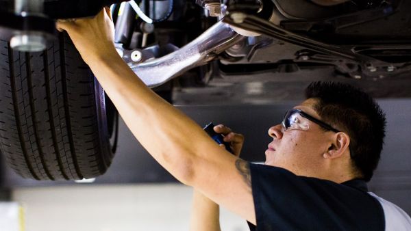 man working under a Lexus car