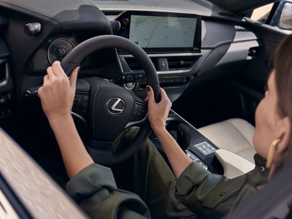 person pressing a button inside their Lexus UX 300e