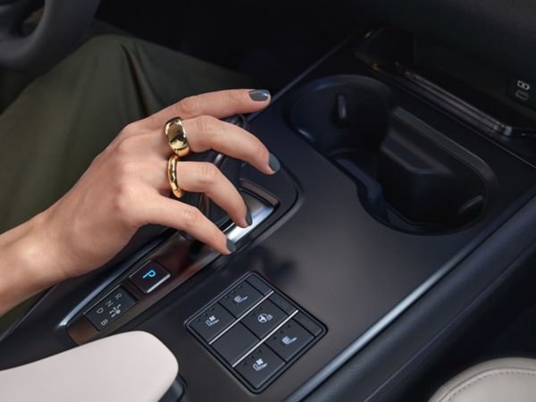 person pressing a button inside their Lexus UX 300e