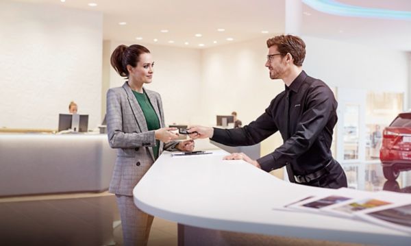 Two people meeting at a Lexus dealership