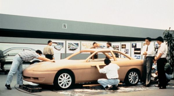 A team of people working on a prototype model car