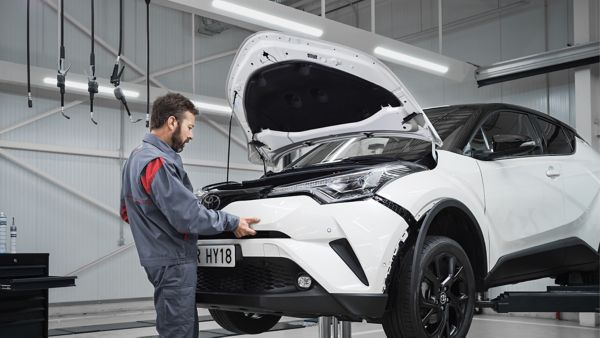 Toyota RAV4 in a mechanics building being fixed by a mechanic