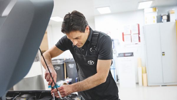 Toyota mechanic working on a car