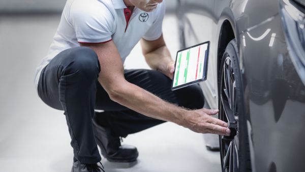 Toyota technician checking tyres