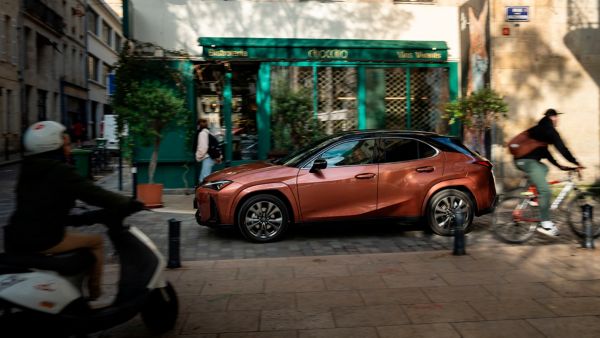 Lexus RZ plugged into a charging tower