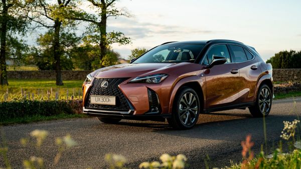 A Lexus UX 300e plugged into a charging port