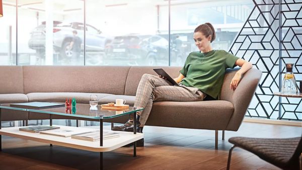 woman sitting in front of a Lexus car