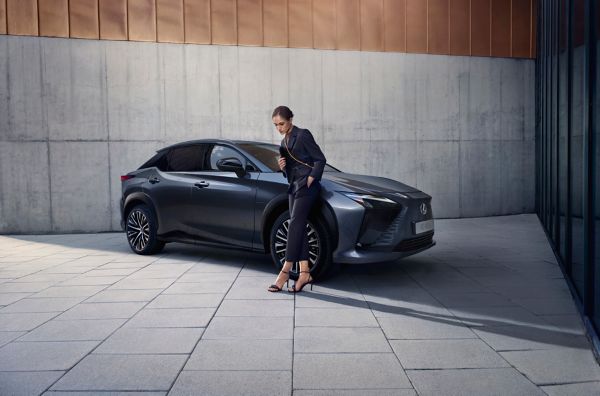 man leaning on a Lexus car