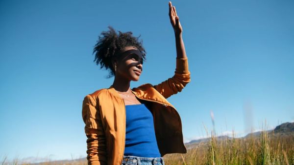 woman covering her eyes from the sun