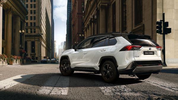 RAV4 white car side angle parked