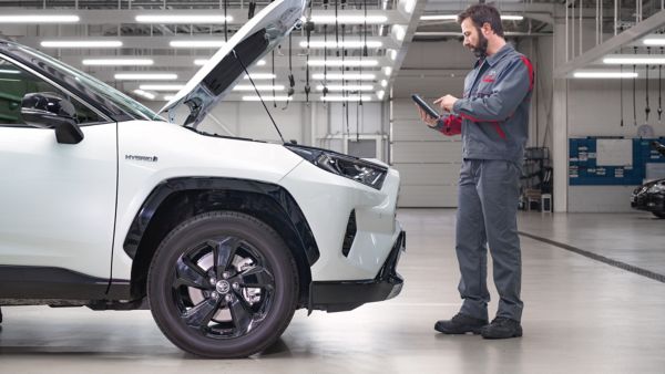 Toyota RAV4 in a mechanics building being fixed by a mechanic