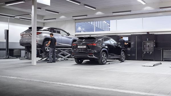 Silver Lexus UX cityscape at night time