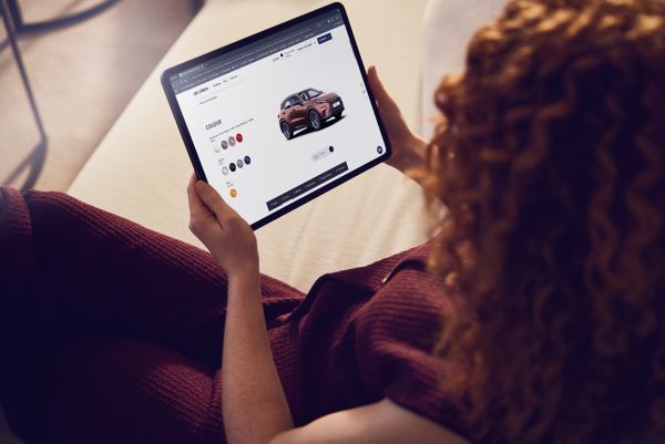 woman looking at a Lexus LBX on a screen
