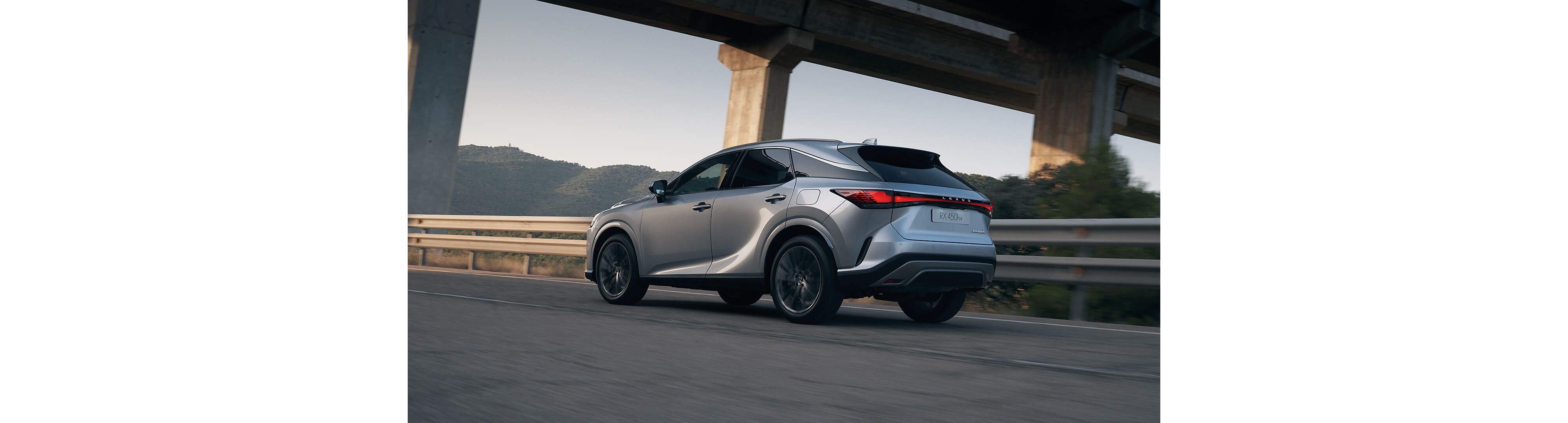Lexus RX 450h+ driving on a road