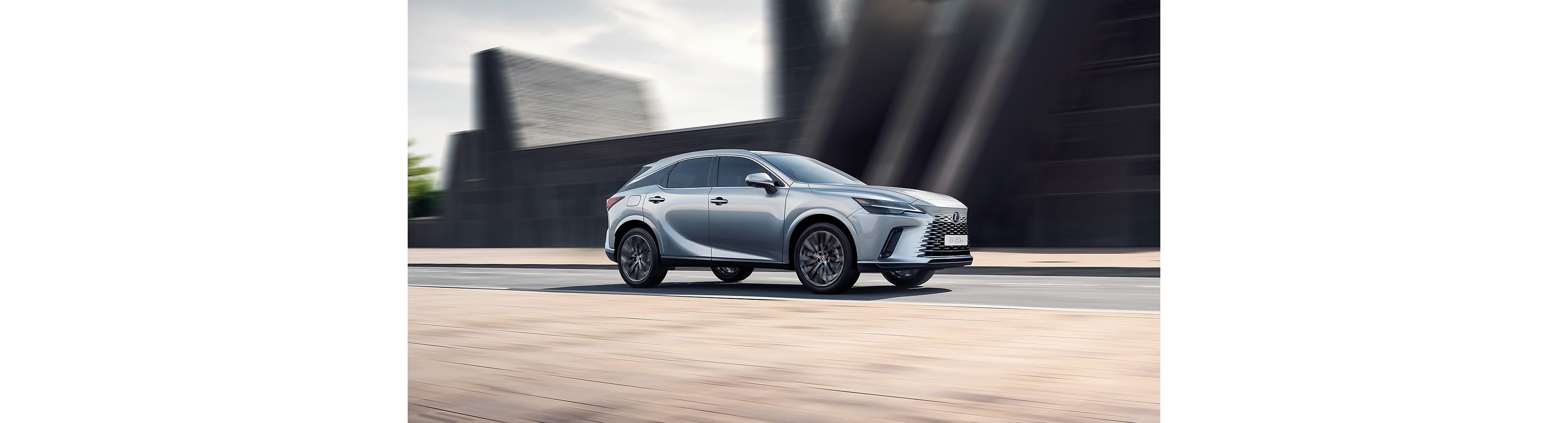 Side view of Lexus RX 450h+ driving
