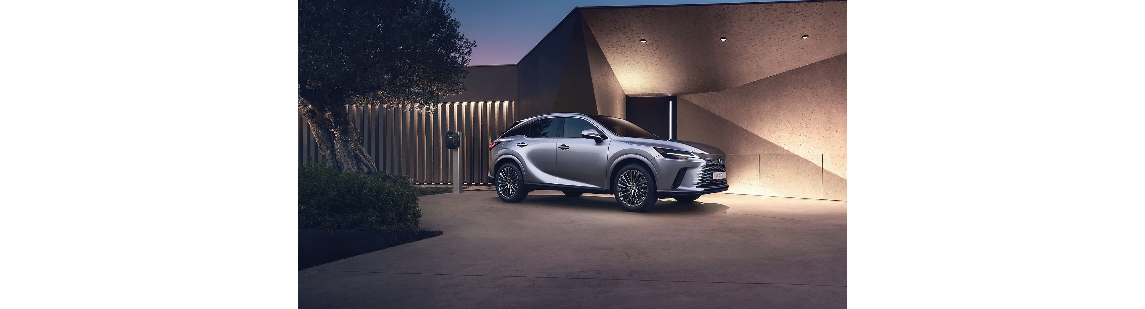 Lexus RX 450h+ plugged into a charging tower