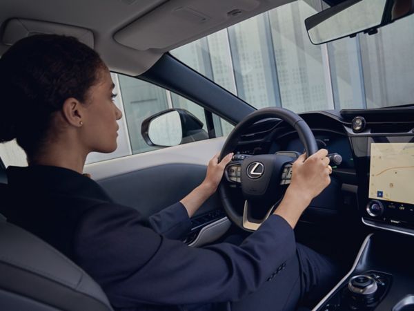 A woman driving a Lexus RZ 450e