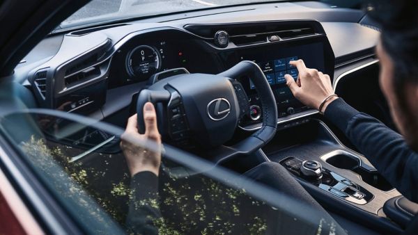 A person sat in the drivers seat of a Lexus