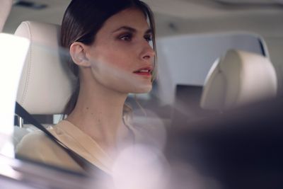 A closeup of a person in a Lexus