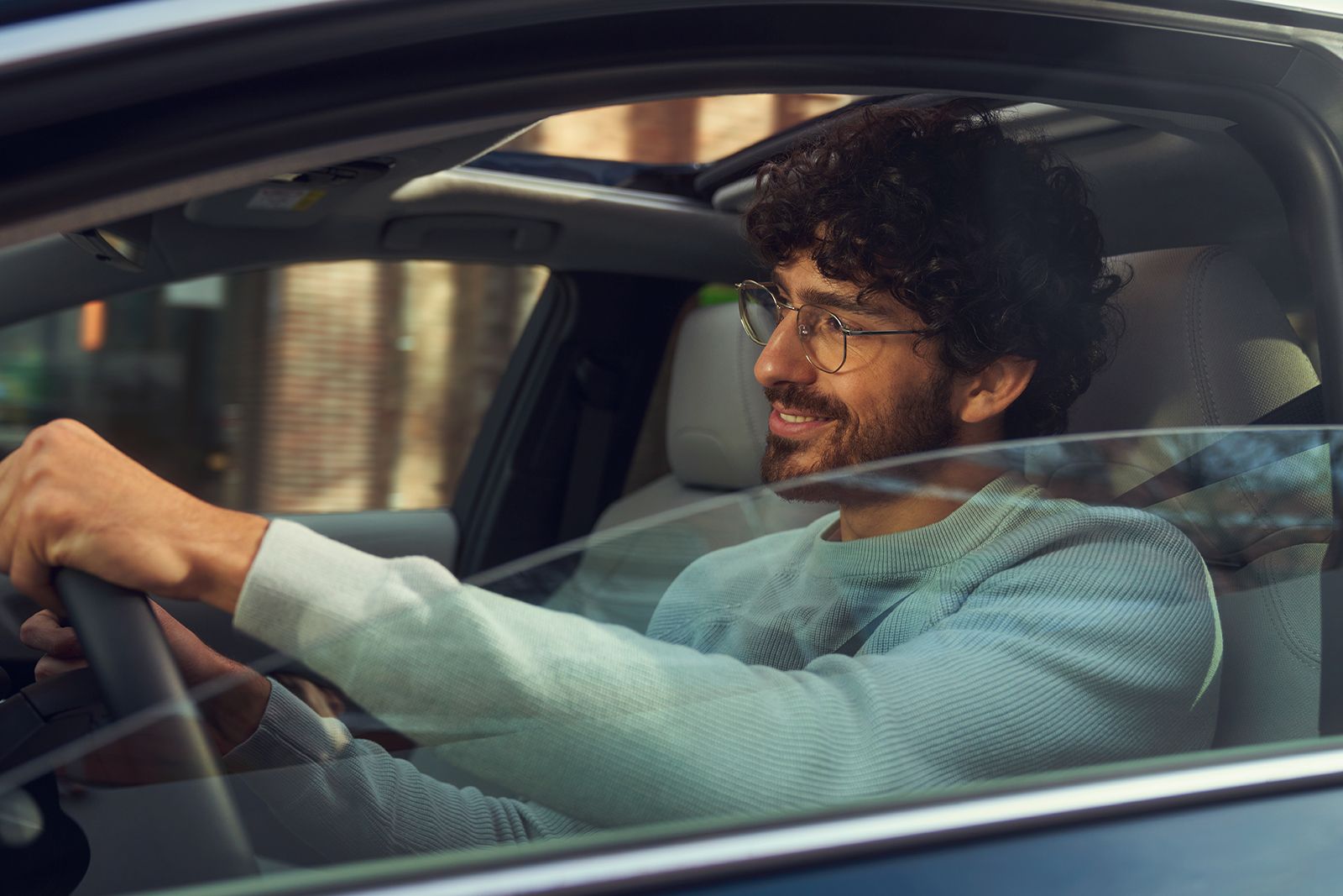 An owner behind the wheel of their Toyota Corolla Sedan