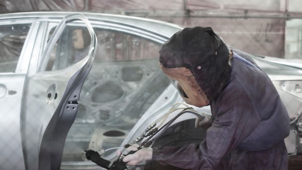 man working on a car inside Lexus lab