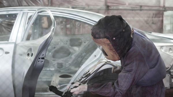 man working on a car inside Lexus lab