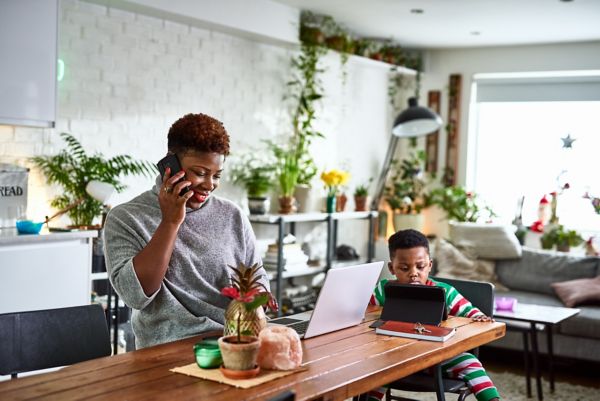 Woman with child at table talking on the phone