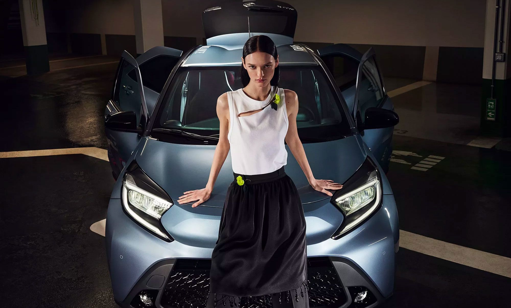 Person leaning on front of car
