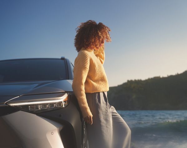 person leaning on a Toyota car