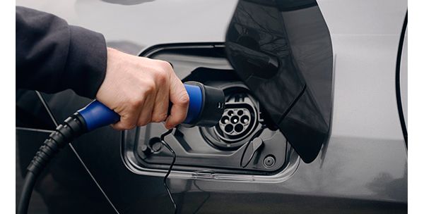 Close up of man charging a Toyota Plugin