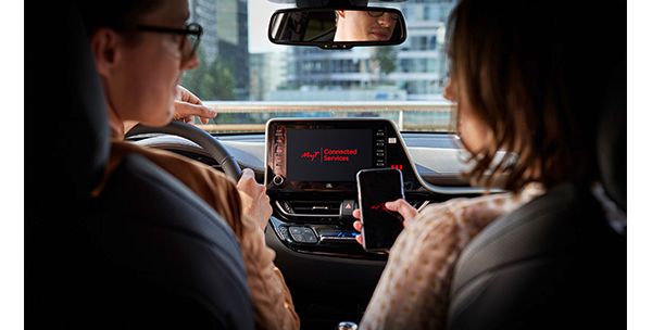 Two people in a car using Connected Services 