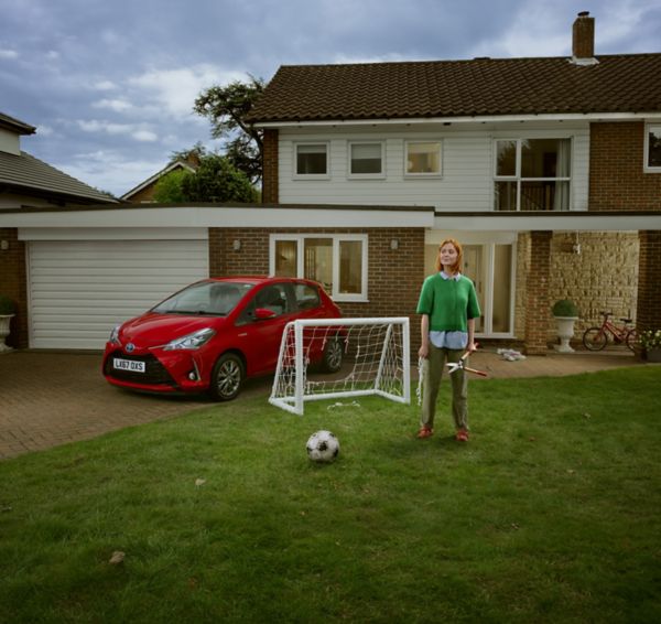 Woman in garden with Toyota Yaris