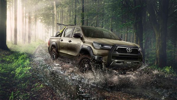 Toyota Hilux driving through a forest