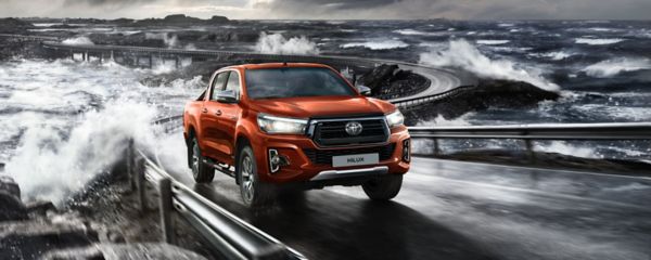 Toyota Hilux driving past the sea