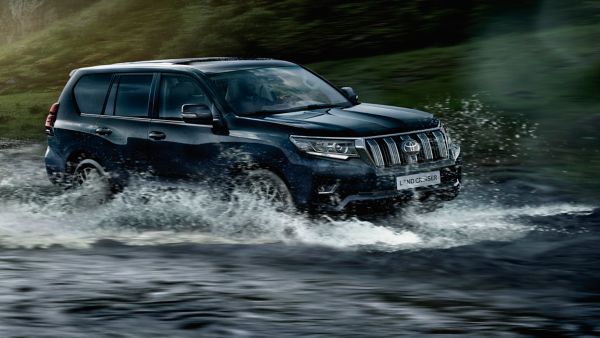 Toyota Land Cruiser driving through a river
