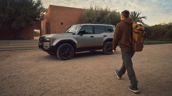 person walking towards a Land Cruiser