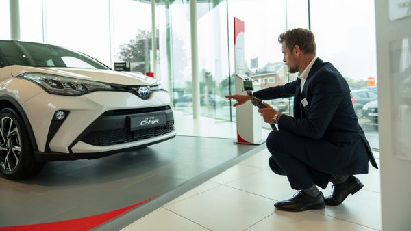 Toyota Showroom man by car