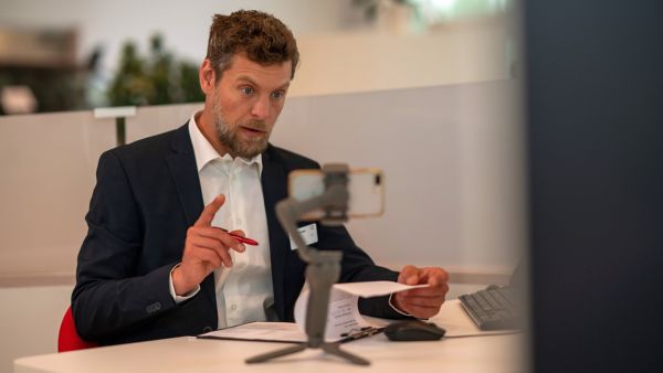 Toyota employee talking on video to a phone