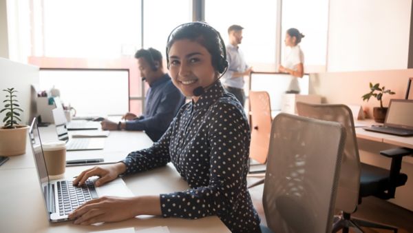 woman smiling with headset on