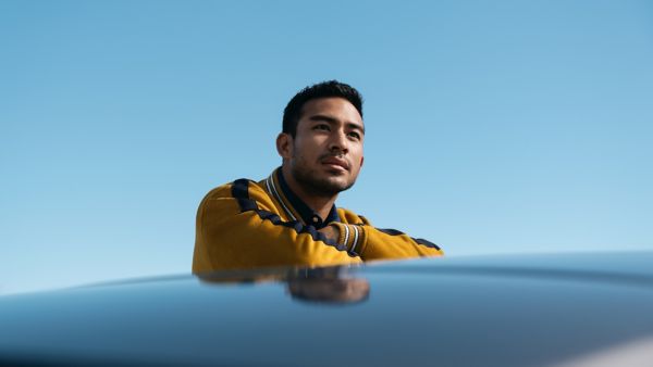 Man leaning on Toyota car