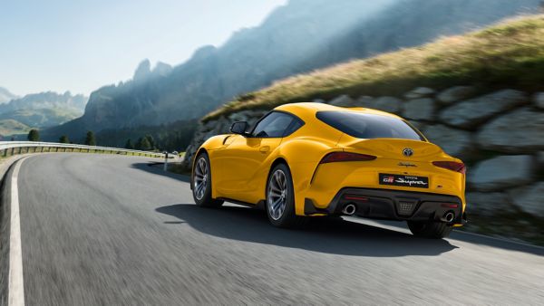 Toyota Supra driving along a road